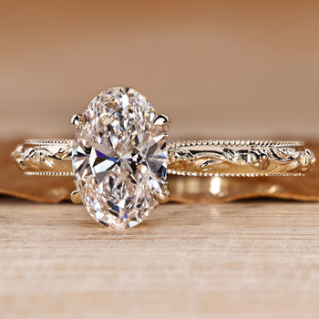 Lab grown diamond oval ring with a botanical vine and leaf shank.