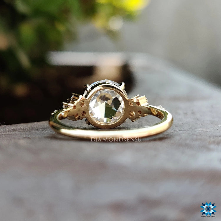 Handmade ring showcasing a rose cut moissanite in yellow gold.