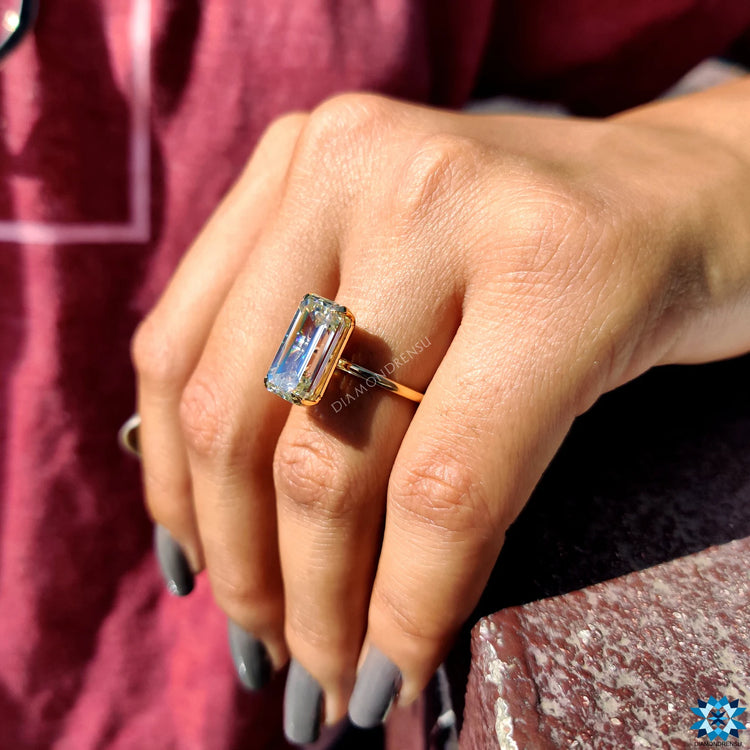 Yellow gold moissanite ring with a polished finish.