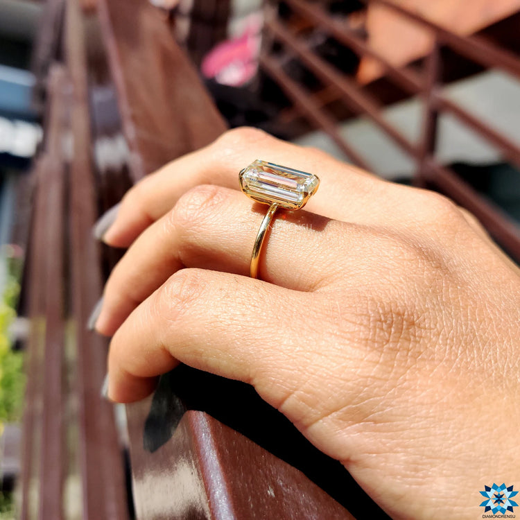 Buy moissanite ring in yellow gold with secure prong setting.