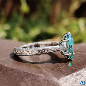 Cyan blue moissanite ring with a bright and bold color.