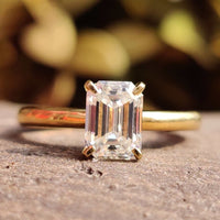 Emerald Cut Moissanite Ring in a classic solitaire design.