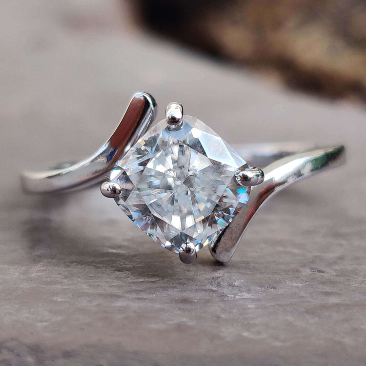 A stunning bypass engagement ring crafted with exquisite detail, displayed elegantly on a velvet box.