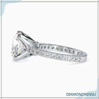 Round cut diamond engagement ring with pave ring details for added sparkle.