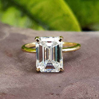 Exquisite emerald cut emerald ring showcased in a handmade ring design.
