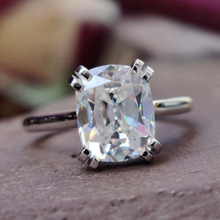 Cushion cut moissanite ring with a stunning cathedral setting for timeless elegance.