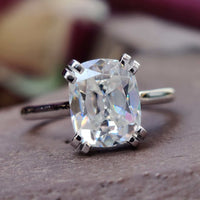 Cushion cut moissanite ring with a stunning cathedral setting for timeless elegance.