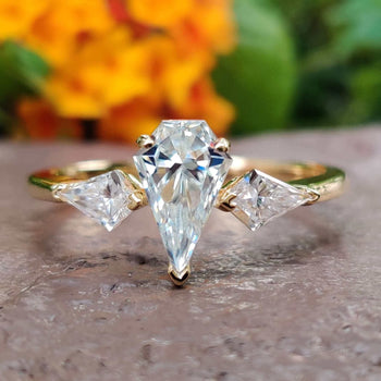 This three stone ring symbolizes the past, present, and future of your love.