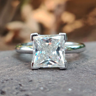 A stunning princess cut moissanite ring featuring a classic V prong setting, perfect for timeless elegance.