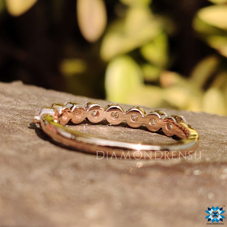 Floating bubble prongs securing round brilliant cut stones.