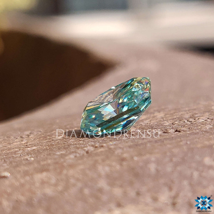 Loose moissanite stone in radiant cut, 1.85 carat weight, and rich blue shade.