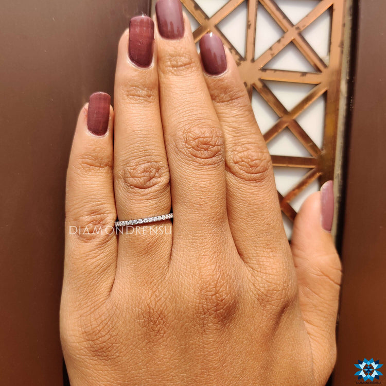 Sleek round cut wedding band with exquisite moissanite stones for a flawless design.