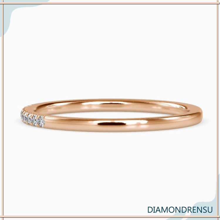 Gold eternity band with round diamonds and minimalist band style.