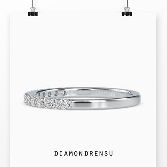 Half eternity wedding band with a diamond half eternity in rose gold.