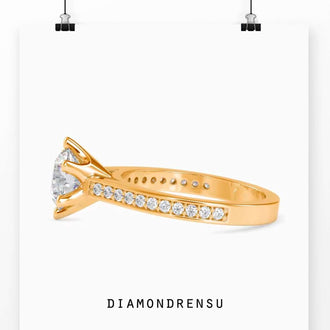 Channel set engagement ring with a rounded diamond in a 6 prong ring setting, perfect for proposals.