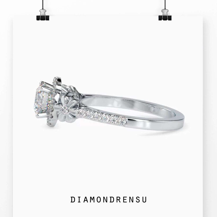 4 prong diamond ring with a floral halo and round diamond setting.