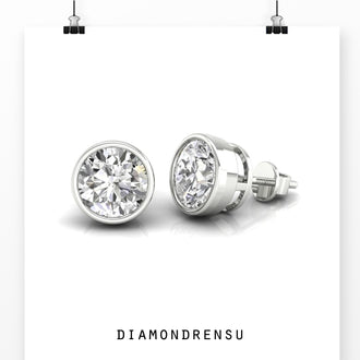 Gold round stud earrings with bezel set diamonds, ideal for an understated luxury look.
