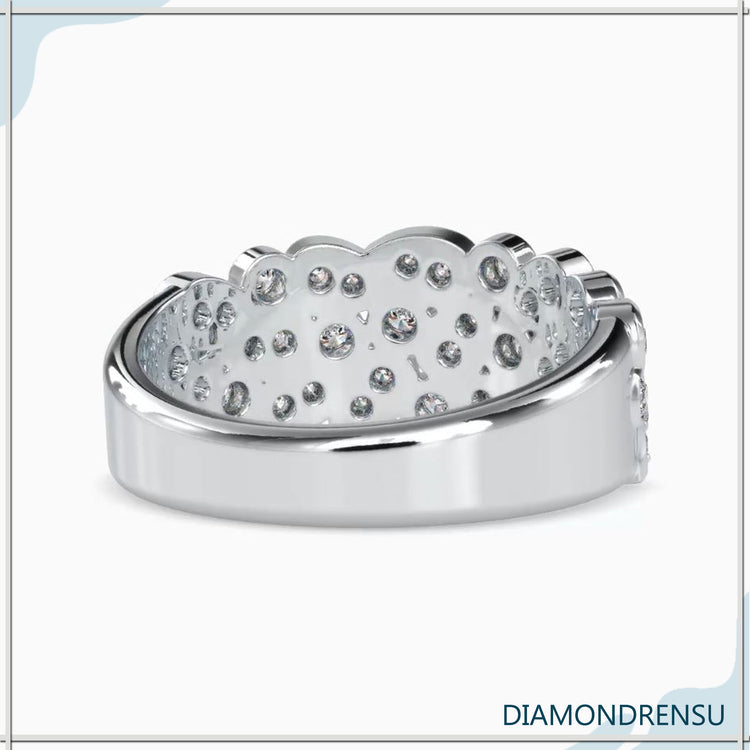 Brilliant cut diamond band with a bezel set round diamond for modern wedding elegance.