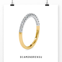 Lab grown diamond wedding band with brilliant cut diamonds in a gold setting.