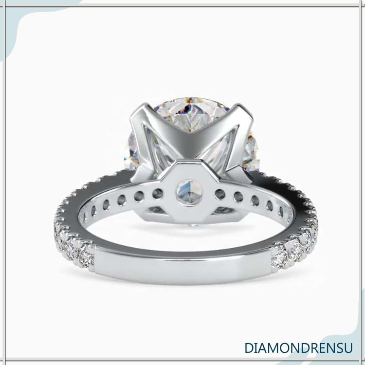 Pave diamond engagement ring with a stunning round cut diamond centerpiece.