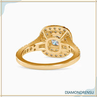 Split shank pave engagement ring with a cushion cut diamond and double halo design.