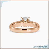 Hidden halo engagement ring with a round brilliant cut diamond and prong setting.