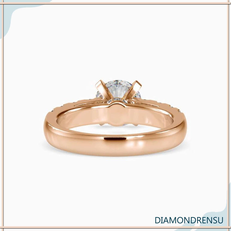 Hidden halo engagement ring with a round brilliant cut diamond and prong setting.