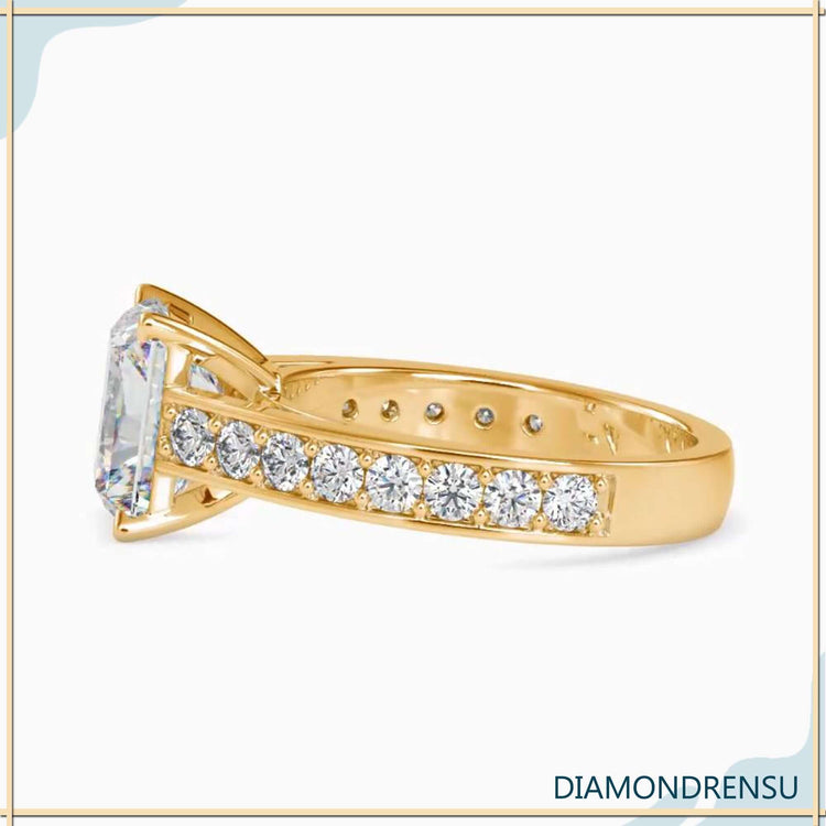 A channel set engagement ring featuring a radiant moissanite engagement ring centerpiece.