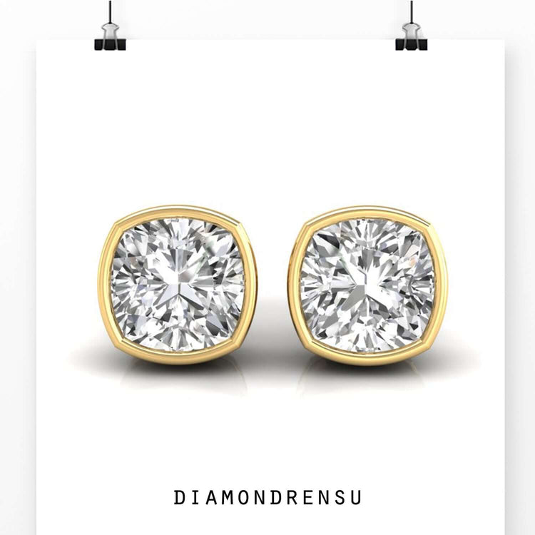 Bezel set diamond earrings featuring cushion cut diamonds for a modern and luxurious style.