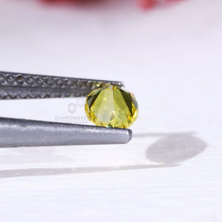 0.60 carat loose oval yellow lab grown diamond.