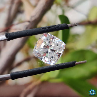 Colorless moissanite sparkling in cushion cut stone.