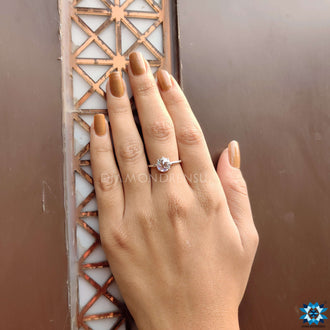 Round moissanite engagement ring with handcrafted details.