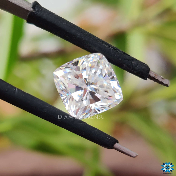 Cushion cut moissanite loose stone beside moissanite stone.