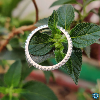 Timeless round eternity band featuring a continuous row of sparkling moissanite.