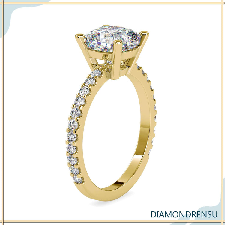 Cushion diamond ring with a pave ring setting and four prong design.