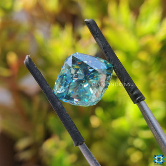 Cushion cyan blue moissanite shown in 7.40 carat size.