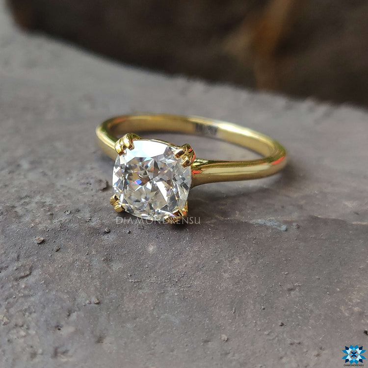 A brilliant Cushion Cut Moissanite set against a delicate band, perfect for any occasion.