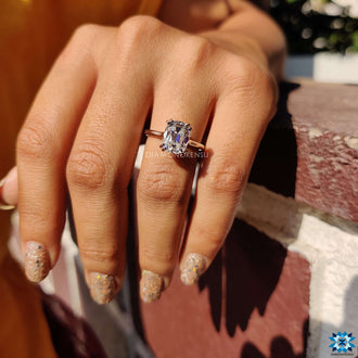 Cathedral setting engagement ring featuring a dazzling moissanite center stone.