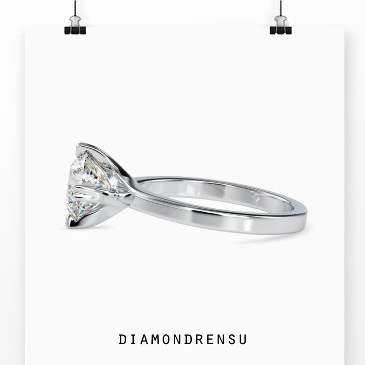 Round brilliant diamond ring with a secure compass setting engagement design.