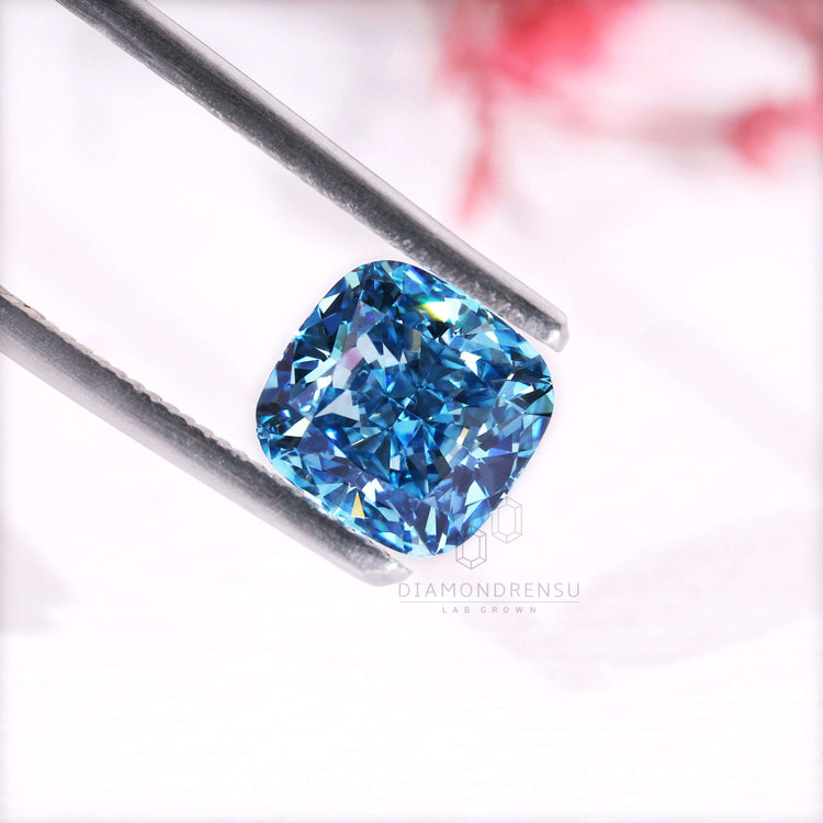 A 2.7 carat diamond in cushion cut with vivid blue lab grown brilliance.
