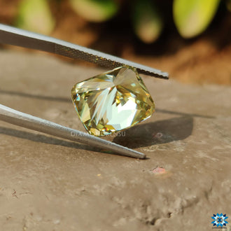 Yellow Cushion Cut moissanite shown in loose form.