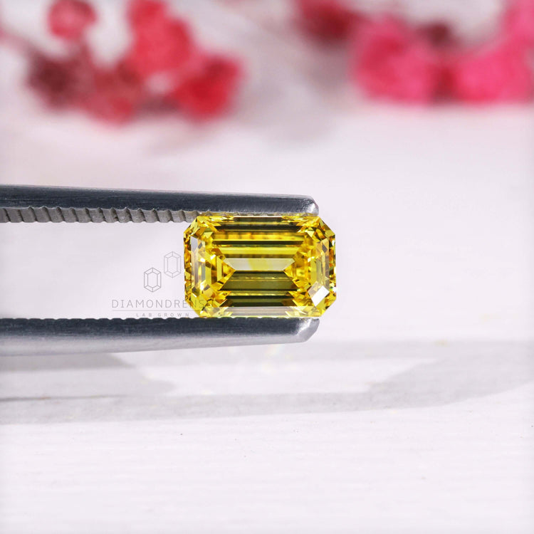 Emerald cut diamond loose stone yellow color.