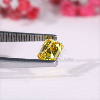 Loose lab grown yellow diamond emerald cut shape.