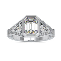 Emerald shaped engagement ring with split shank design in white gold