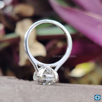 Round solitaire engagement ring featuring a radiant moissanite stone.
