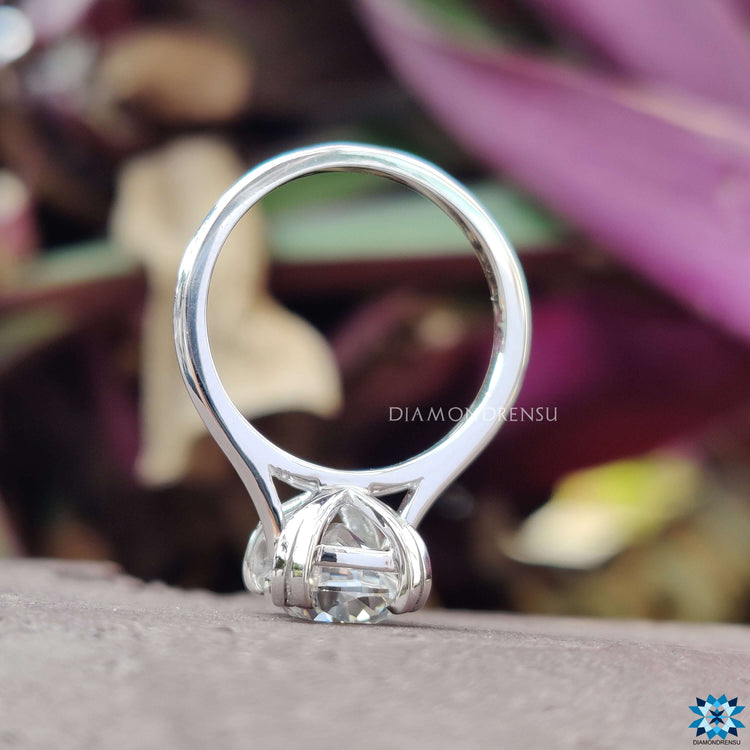 Round solitaire engagement ring featuring a radiant moissanite stone.