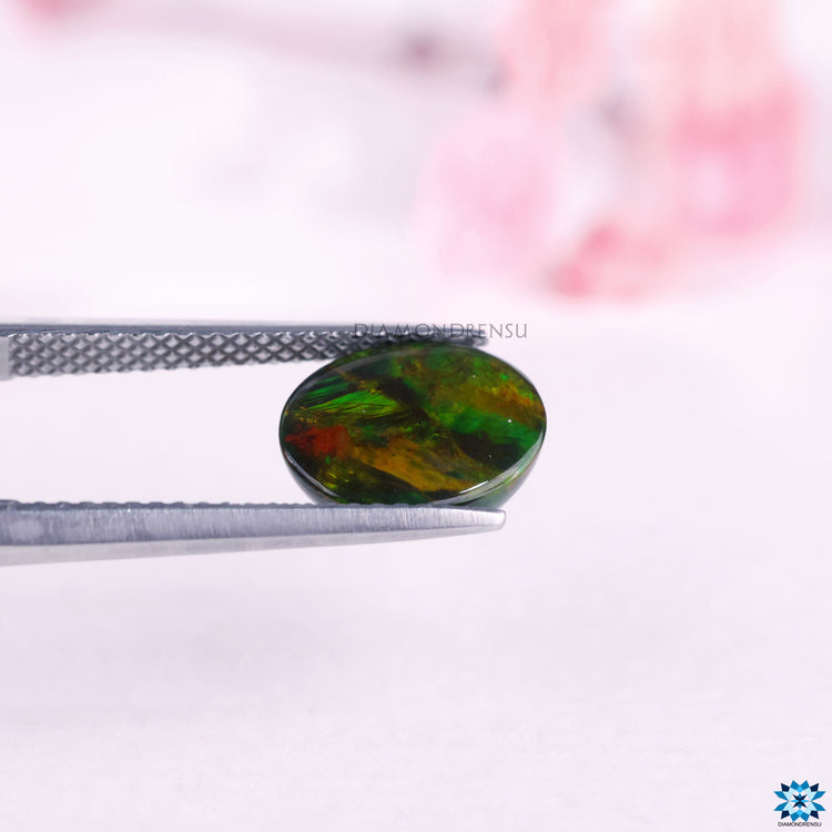 Opal Ethiopia gem shown as October birthstone with natural oval cut from Diamondresnu gemstone.