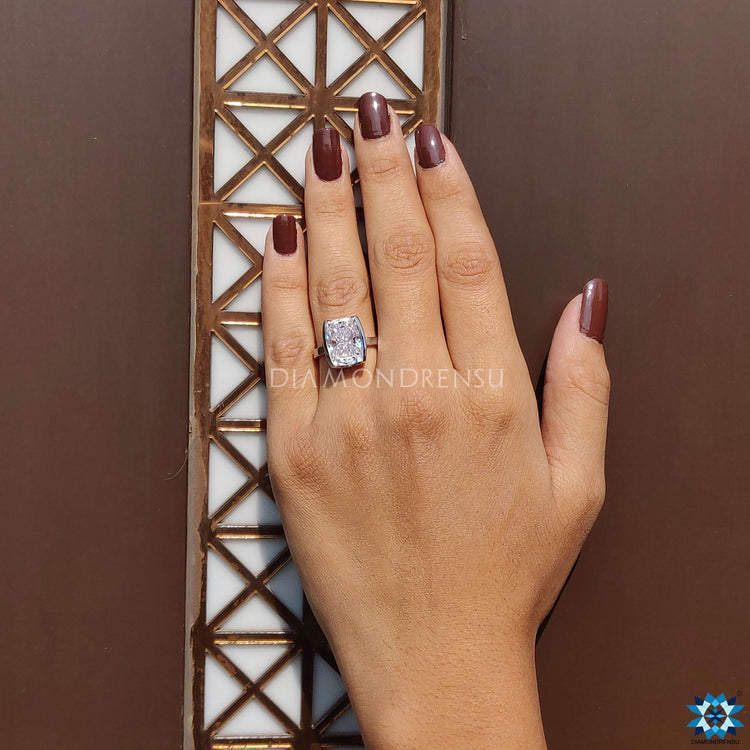 Solitaire bezel ring featuring an elongated cushion stone.