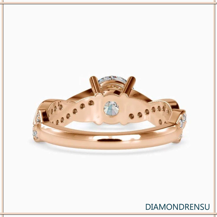 Elegant white gold twist ring with a round diamond in a 4 prong ring setting.