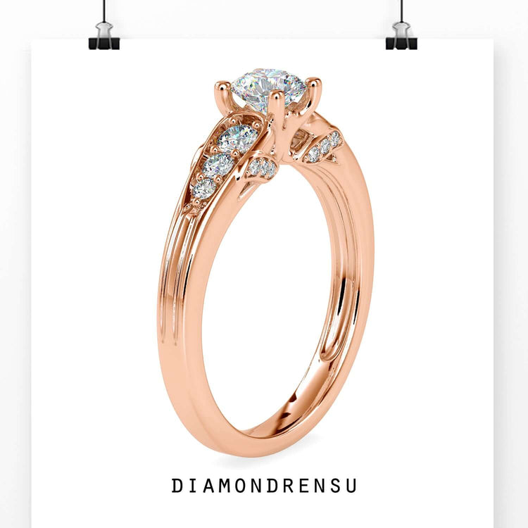 Round diamond engagement ring with side stones and a tapered band.